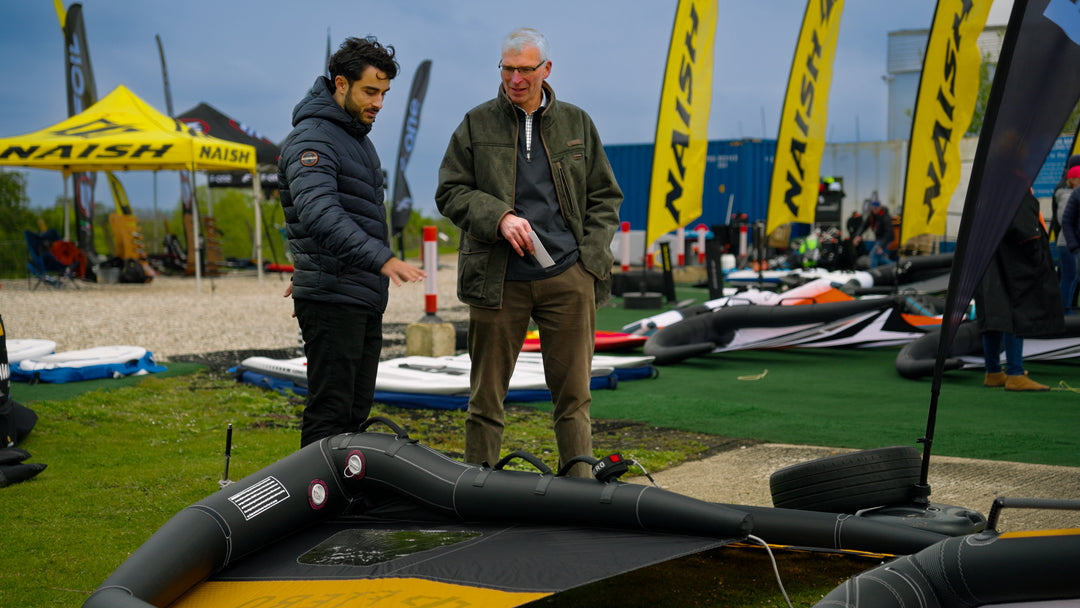 flysmart: wingfoiling festival 2 people looking at wings